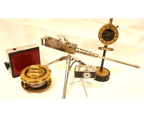 Five novelty table cigarette lighters, machine gun, globe clock, Elector Panther and another. P&amp;P Group 2 (£18+VAT for th