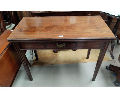 A Georgian tea table with rectangular fold-over top and frieze drawer, on square tapering wave moulded legs The gate-leg is a