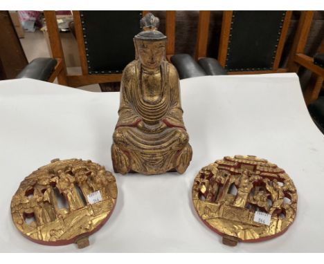 A Chinese carved wood gilt figure of a seated buddha and 2 Chinese circular carved wood wall plaques.&nbsp;&nbsp;Buddha: Good