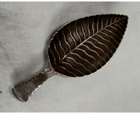 A Georgian hallmarked silver caddy spoon, the bowl in the form of a leaf with monogram to the terminus. Birmingham 1800, make