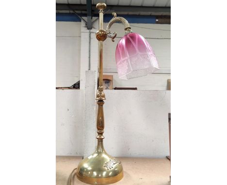 An Edwardian brass desk lamp with cranberry shade (good condition)