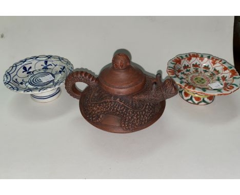 A Chinese Yixing teapot with relief dragon form with head as spout, mark to base and two Chinese pedestal dishes (one restore