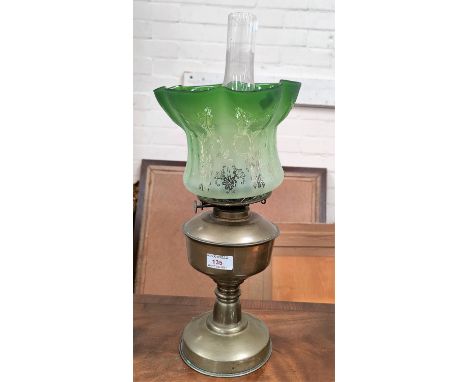 A brass table lamp and shade (shade rim chip); a vintage case 