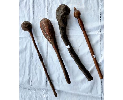 An Aboriginal tribal painted club length 44cm, two carved tribal clubs and a carved tribal stick with spherical terminal 