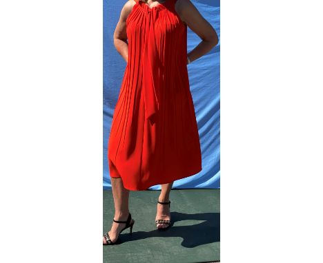 An ESCADA bright orange sleeveless dress with tie neck, pleated front and side pockets (size 12); an ESCADA flame coloured V 