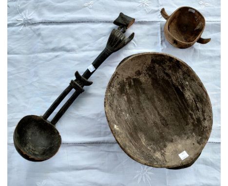 A carved wooden African tribal ladle with a hand rest etc (part of terminal missing) a smaller carved wooden bowl and a small