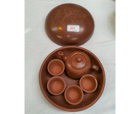 A Chinese redware ceramic cushion shaped circular box containing a miniature tea service, incised decoration with inscription