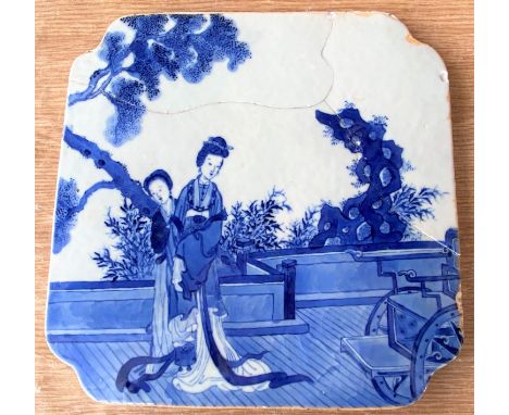 A 19th century Chinese blue and white shaped square blue and white tile with woman on balcony, length 26cm (a.f. re-stuck).&n