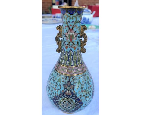 A Chinese highly detailed Cloisonne vase in the Qing manner with light blue group and various other colours, with gilt fixing