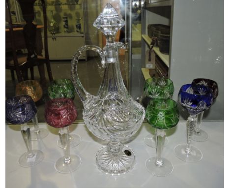 A cut glass decanter, raised on a circular foot, with retail box, H. 39cm, together with nine wine glasses, with cut coloured