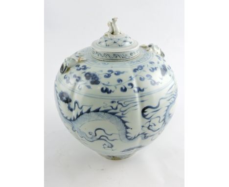 A Chinese blue and white gourd-shaped lidded vase, with faux ring handles, decorated with dragons chasing a flaming pearl, H.
