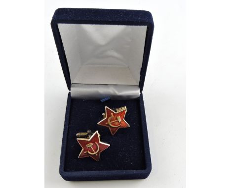 A pair of enamel cufflinks, of star form with hammer and sickle, converted from Soviet army cap badges.