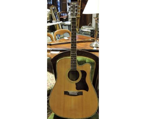 An acoustic guitar by Woods Instruments, the faux ivory and mother-of-pearl band within a padded slip case.