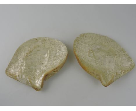 A pair of early 20th century Chinese mother-of-pearl shells, carved with figures in an extensive landscape, H. 18cm, (2)