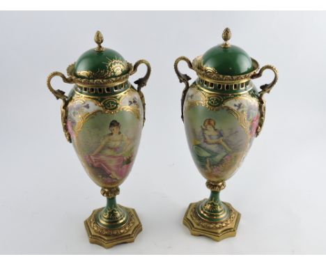 A pair of 19th century German style ceramic and gilt metal vases, decorated with vignettes of beauties in a landscape, H. 30c