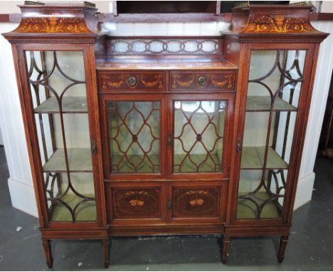 A fine Edwardian mahogany and inlaid Chippendale Revival display cabinet, the central section with a pierced gallery above an