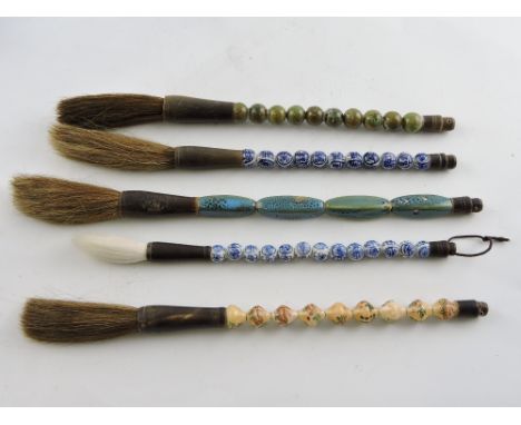 Five Chinese ceramic calligraphy brushes. 