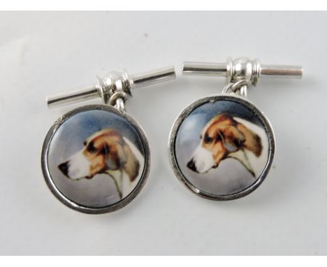 A pair of circular white metal chain cufflinks, set with dog's heads.