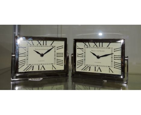 A pair of chromium plated Art Deco style bedside timepieces, the rectangular dials marked roman numerals, W. 20cm.