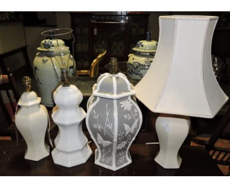 A pair of octagonal cream ceramic baluster table lamps , H 30cm, together with another similar and a moulded grey ceramic lam