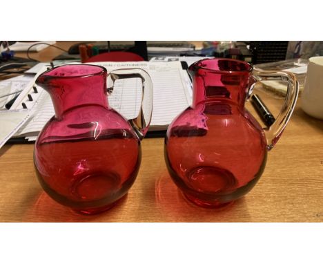  Sale Item:    2 CRANBERRY GLASS JUGS   Vat Status:   No Vat   Buyers Premium:  This lot is subject to a Buyers Premium of 15