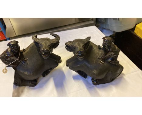  Sale Item:    2 CARVED MEN ON BULLS (AF)   Vat Status:   No Vat   Buyers Premium:  This lot is subject to a Buyers Premium o