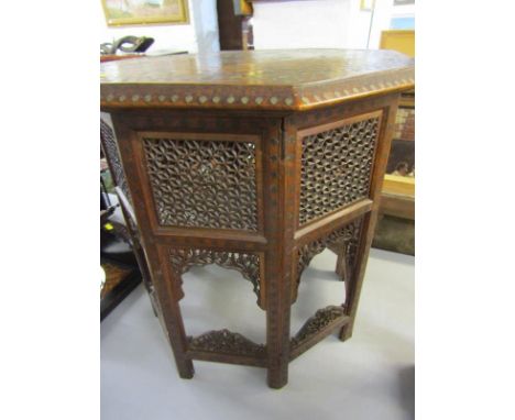 PERSIAN BRASS INLAID OCTAGONAL OCCASIONAL TABLE with pierced grille panels, with attractive floral inlaid top, 51cm width 700