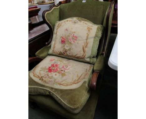 19th CENTURY GREEN UPHOLSTERED WING ARMCHAIR, carved ball and claw feet with tapestry cushions