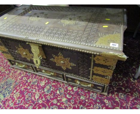 NORTH AFRICAN BRASS MOUNTED TRUNK, triple base drawers with carved and pierced brass applied decoration, 90cm width