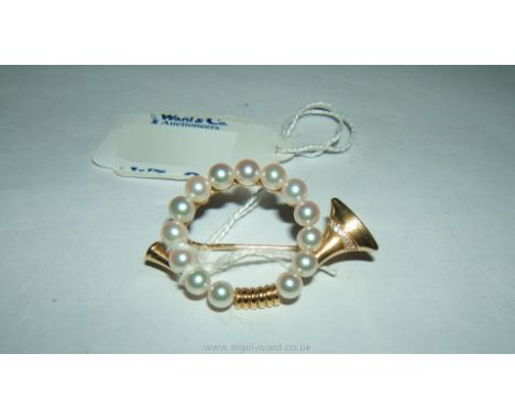 An 18ct gold Mikimoto, South Sea Pearl trumpet Brooch with five small Diamonds.