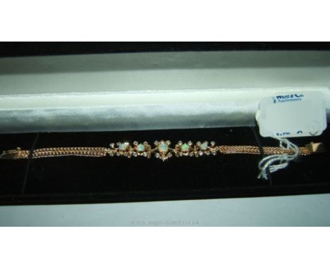 A continental 14k gold Opal and Diamond Bracelet with openwork setting and chain rope.