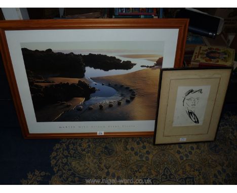 A framed pen and ink portrait drawing along with a large print of a beach scene by Martin Hill.