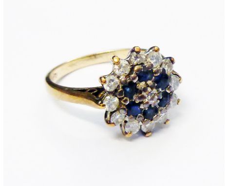 A hallmarked 375 gold ring encrusted with small sapphires and diamonds