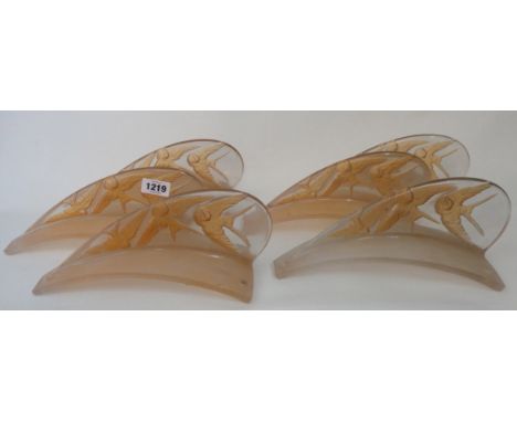 A Lalique Hirondelles twelve section centre light fitting depicting swallows moulded in intaglio in light brown stained glass
