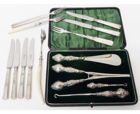 A cased silver handled button hooks, glove stretcher and shoe horn set with ornate embossed decoration - sold with silver han