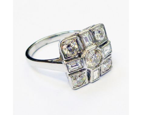 A marked PLAT Art Deco style panel ring, set with central diamond within an alternating baguette and brilliant cut eight ston