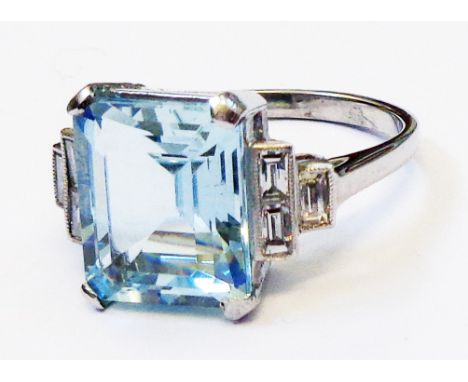 A marked PLAT Art Deco style ring, set with central 5.35ct. emerald cut aquamarine and six flanking baguette diamonds to step