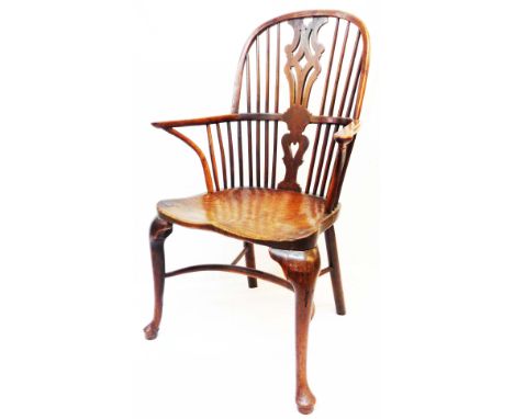 An 18th Century yew and elm Windsor elbow chair with pierced splat and stick back, wide moulded solid elm seat and crinoline 