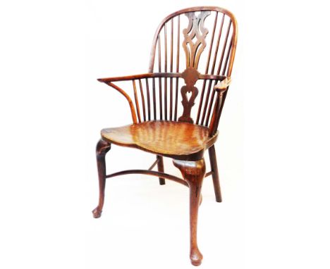 An 18th Century yew and elm Windsor elbow chair with pierced splat and stick back, wide moulded solid elm seat and crinoline 