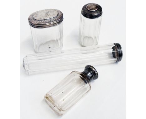 Three silver topped faceted cut glass dressing case bottles and a cologne bottle similar