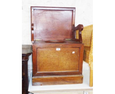 An Edwardian mahogany and strung lift-top box commode with folding armrests