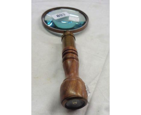A reproduction magnifying glass with compass to finial