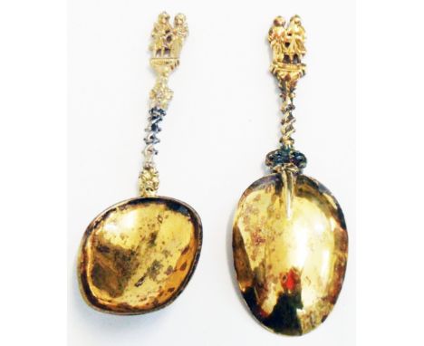 Two similar Dutch silver gilt ornate figural topped spoons with twist stems and remains of "fantasy" marks to bowl backs