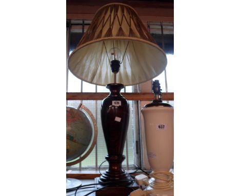 A modern carved wood table lamp with shade