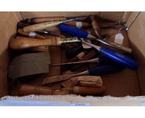 A box containing assorted woodworking tools including Marples wood turning chisels, various vintage chisels and gouges, tape 