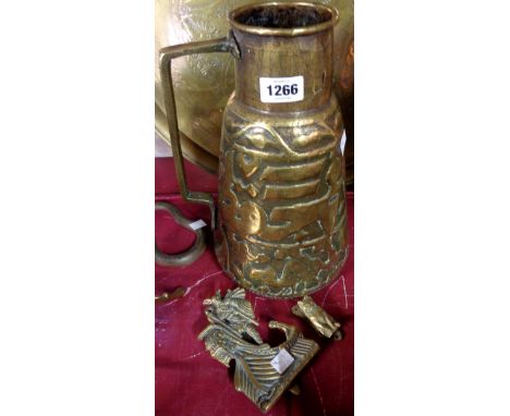 A large Persian embossed brass jug (a/f) - sold with a brass Norseman door knocker and a cat example similar