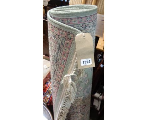 A modern machine made rug with Middle Eastern style floral medallions on pale jade ground, within a multi border - 5' 8" X 2'