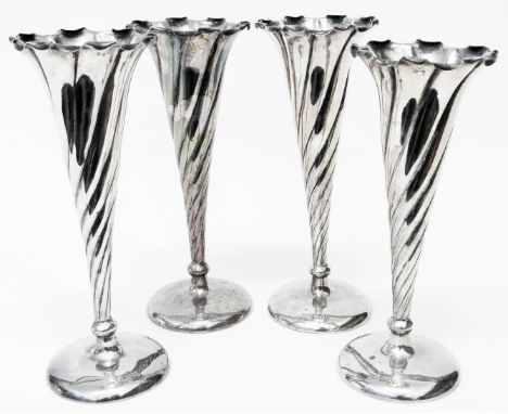 A set of four 7 1/2" silver trumpet vases with shaped rims and spiral decoration set on loaded circular bases - London 1902/0