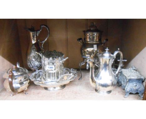 A quantity of silver plated items including a spirit percolator, cake basket, bottle coaster and pewter tea caddy, etc.