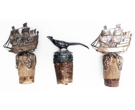 An import marked silver mounted bottle cork of pheasant design - sold with a pair of white metal galleon pattern similar